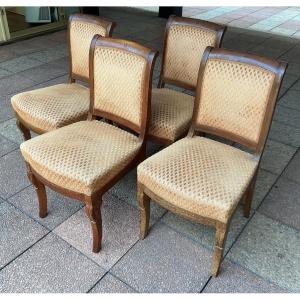 Quatre chaises en noyer incrusté de motifs en amarante.