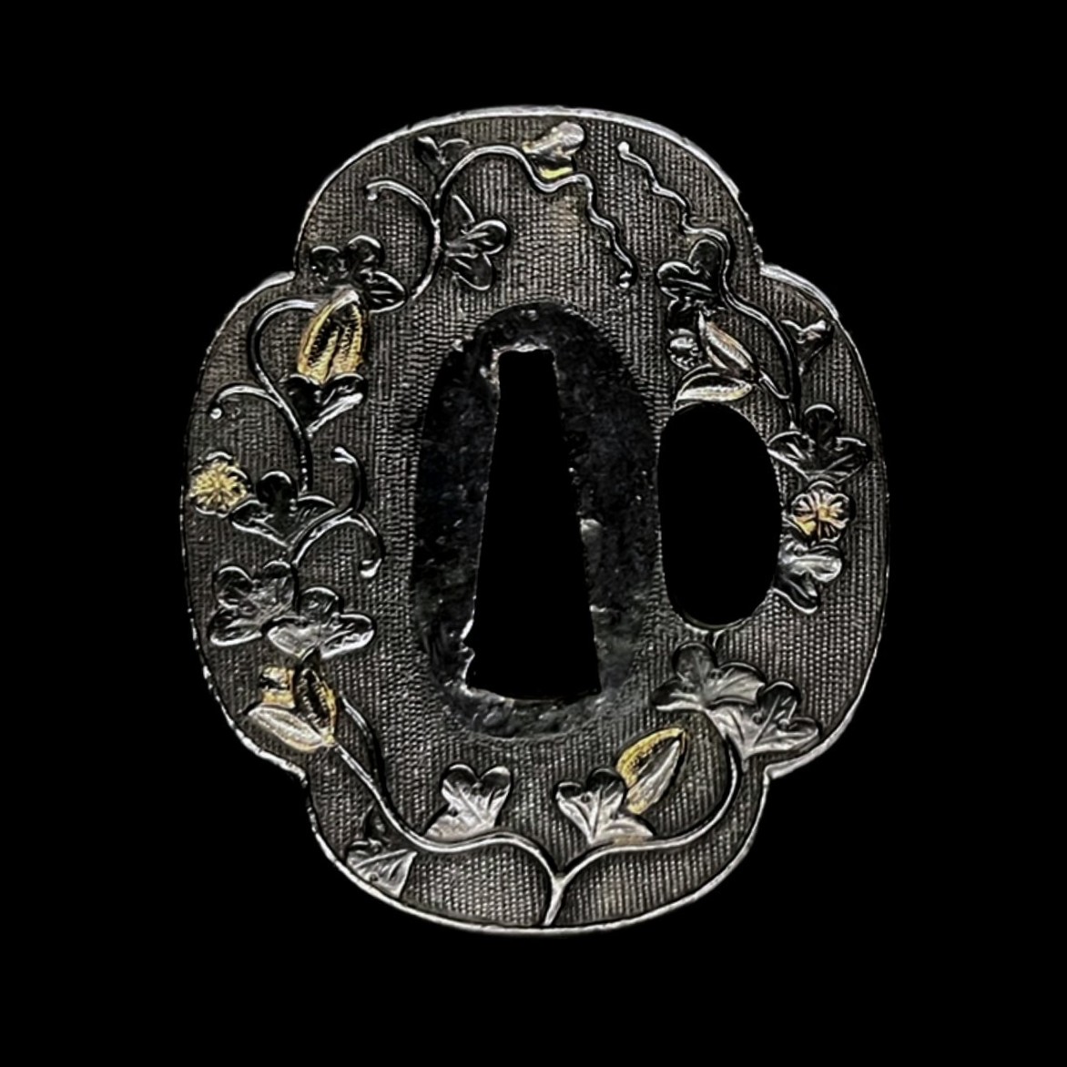 Tsuba mokko-gata en shakudō à décor végétal – Japon, époque Edo (XVIIe–XIXe siècle)