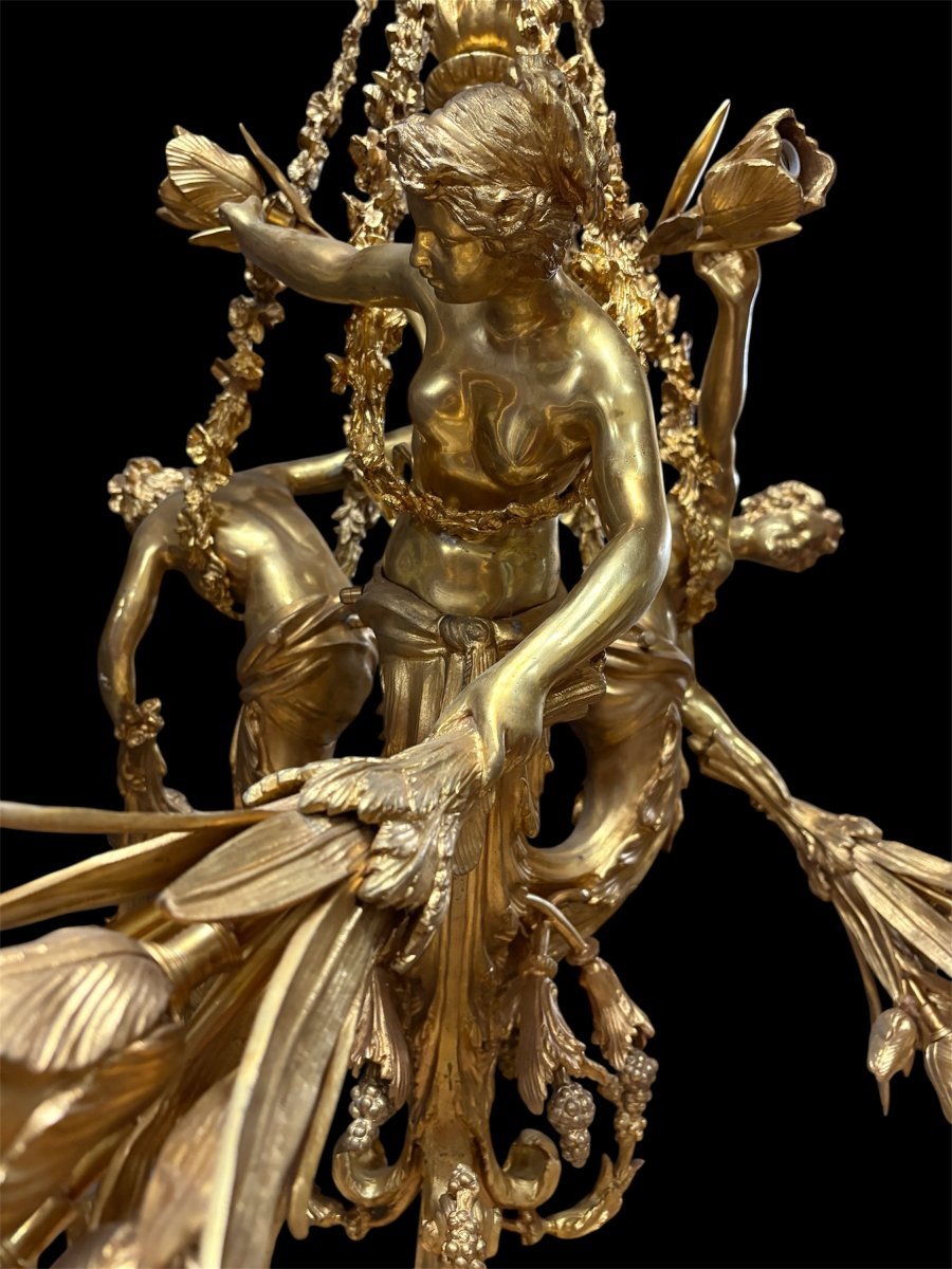 A Pair Of Large 20th-century Gilded Bronze Chandeliers Depicting Three Mythological Women.