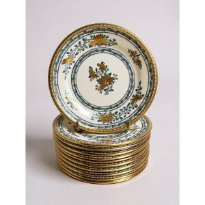 12 assiettes en porcelaine à décor polychrome et or, monture  en argent massif, poinçon Minerve