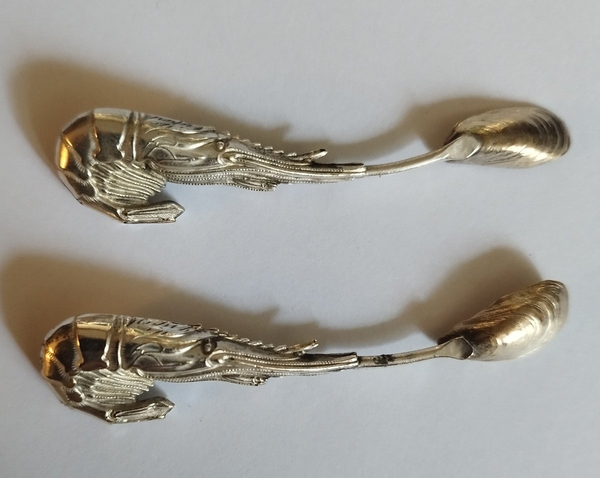 Two Silver Spoons Shaped Like A Lobster And A Seashell 