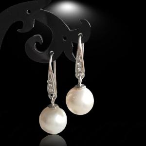 A Pair Of Australian 10 Mm White Pearl And Diamond Dangling Earrings. 1970s