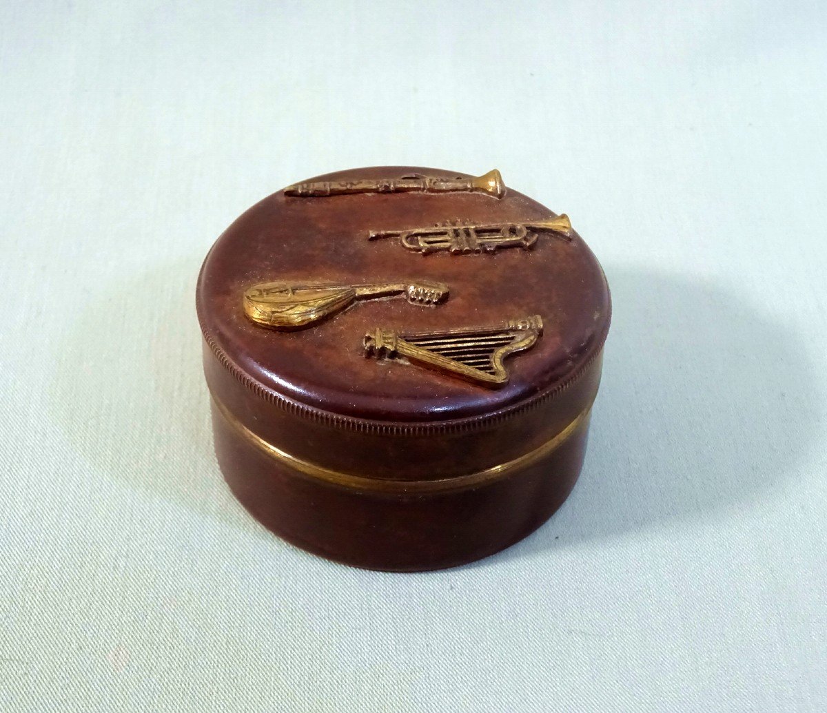 Old Circular Copper Dinanderie Rosin Box With Applied Musical Instrument Decoration