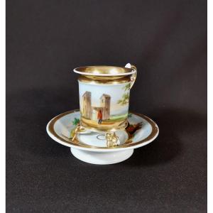 Empire Period, Paris Porcelain Tripod Cup Decorated With A Fantasy Landscape, Rich Gilding And Handle In Motion