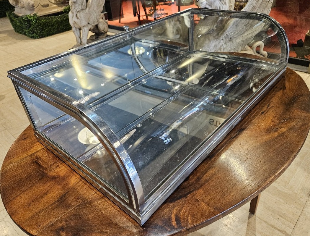 Countertop Display Cabinet With A Curved Hinged Door Made Of Chrome-plated Brass.