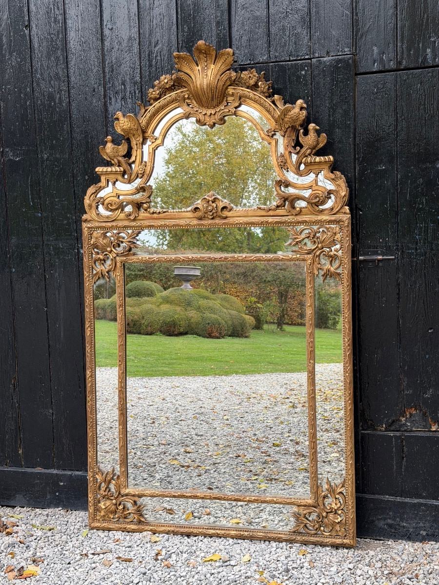 Miroir de style Régence en bois doré, XIXème siècle 
