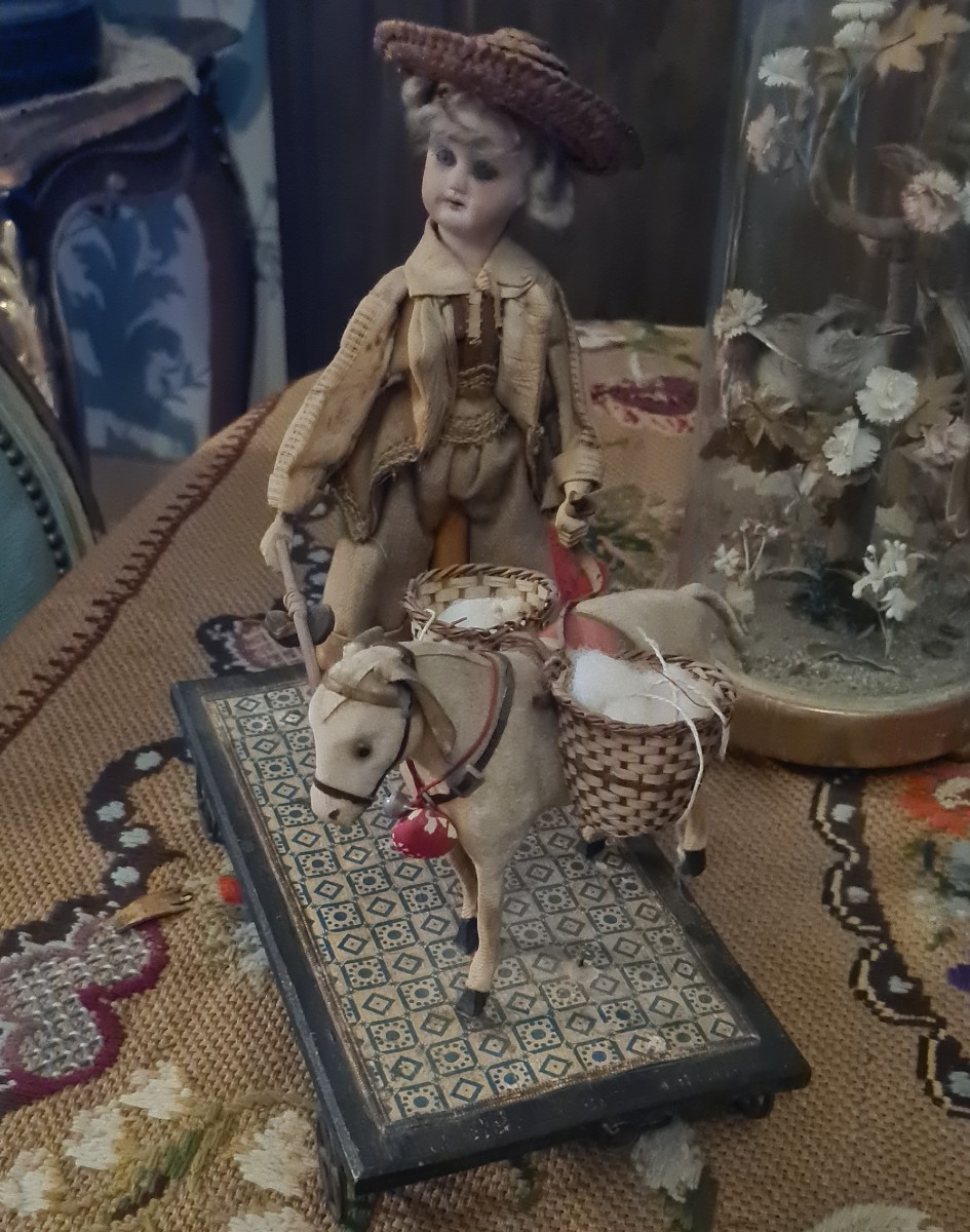 Antique Toy With A Mechanical Mechanism. A Cart With A Donkey And A Bisque Doll.