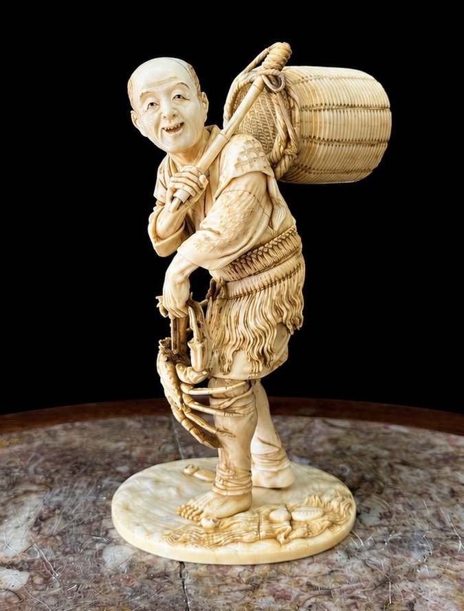 Important Ivory Okimono Depicting A Crab Fisherman