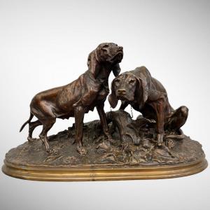 Bronze group representing two dogs of the Saintongeoise breed by Pierre-Jules M&egrave;ne .<br />
The group is made up of the French female dog &quot;Bellotte&quot; and the female dog &quot;Chienne de meute avec ses petits&quot;, both modeled in 1856 .<br />
The edition of this group was an immediate and lasting success , in particular among amateurs of subjects of hunting and venery .<br />
Period XIX th century .<br />
Signature of sculptor &quot;PJ .MENE&quot; on the oval, naturalistic, richly chiseled terrace .<br />
In a perfect state<br />
<br />
<em><strong>Page 126 (CHI 51) , Pierre - Jules M&egrave;ne - Catalogue raisonn&eacute; &quot; Michel Poletti &quot; et &quot; Alain Richarme &quot; .</strong></em><br />
<br />
<u><strong>Pierre-Jules M&egrave;ne (1810- 1879)</strong></u><br />
<br />
Pierre-Jules M&ecirc;ne , is a French sculptor , born March 25 , 1810 in Paris , city where he died on May 20 1879 .<br />
<br />
He is considered to be one of the main representatives of animal sculpture in the 19th century .<br />
Pierre-Jules M&ecirc;ne produced many animal sculptures , particularly in vogue under the Second Empire, like Antoine-Louis Barye , Auguste Ca&iuml;n , Pierre Louis Rouillard and , later , Fran&ccedil;ois Pompon .<br />
<br />
M&ecirc;ne specialized in small bronzes, and did not produce work for public statuary .<br />
His animal subjects have enjoyed great popular success .<br />
Exclusive publisher of his works , the perfection of his productions is widely recognized .<br />
He reveals himself , with Barye , as the one whose success has been the most constant , and this over the longest period .<br />
<br />
M&egrave;ne appears to be one of the best wax practitioners of his time .