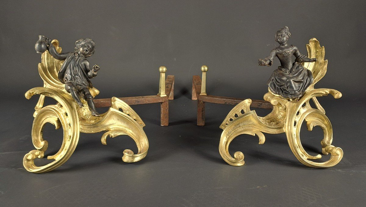 Pair Of Louis XV Andirons In Gilded Bronze With Black Patina