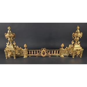 Barre de foyer / chenets de style Louis XVI en bronze doré