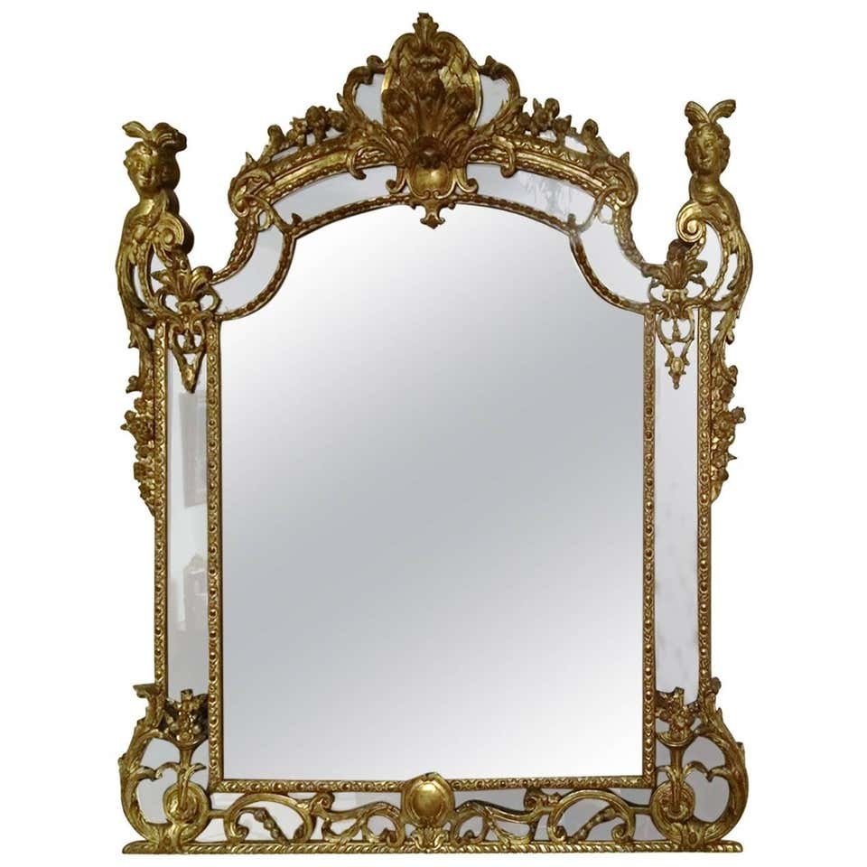 Exceptionnel miroir de boiserie d'Epoque Régence en bois sculpté et doré