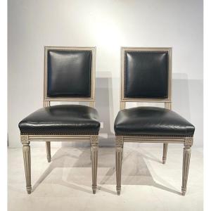 Pair Of Louis XVI Style Chairs In Patinated Wood And Black Leather Seat