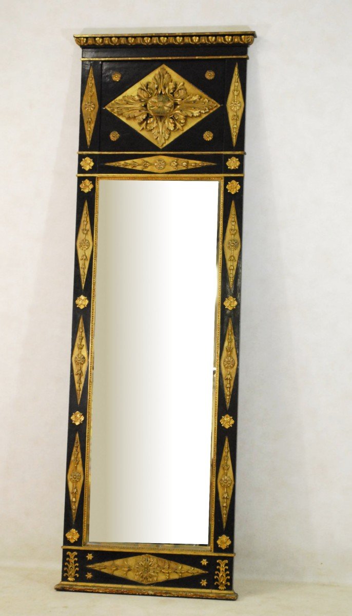 A South German Black-painted, Parcel-gilt And Composition Pier Mirror 