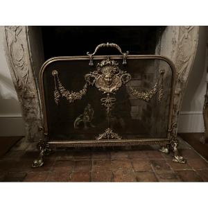 Pare  - étincelle en bronze à décor de masque de femme NIII