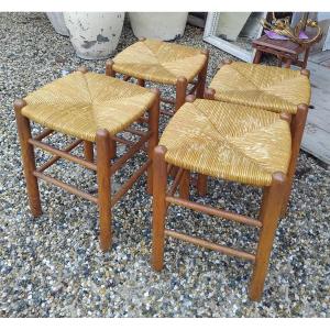 Suite de quatre tabourets - chêne et paille -  v . 1950.