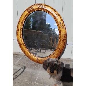 Oval Mirror Composed Of A Red And Gold Lacquered Wooden Frame Decorated With Foliage And Coat Of Arms.