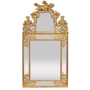 A Decorative Mirror With Soffits And A Pediment