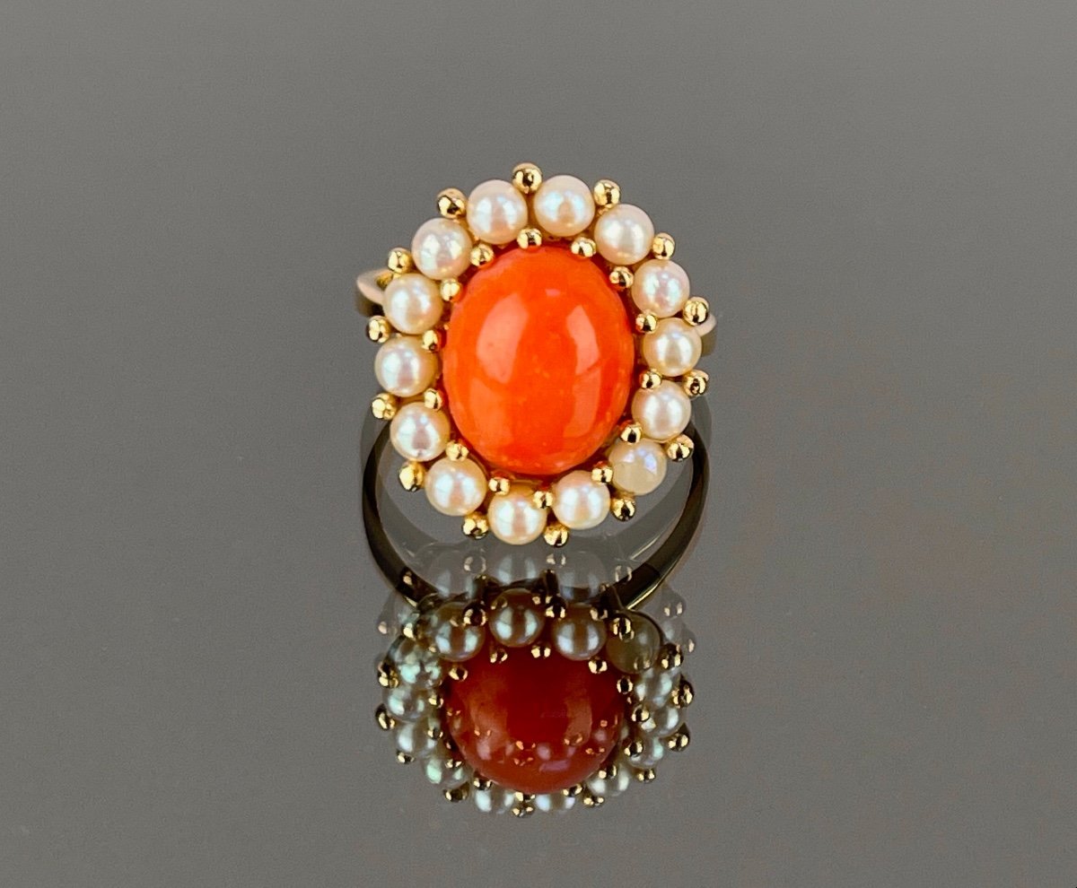 Gold Ring Adorned With A Coral Surrounded By Pearls