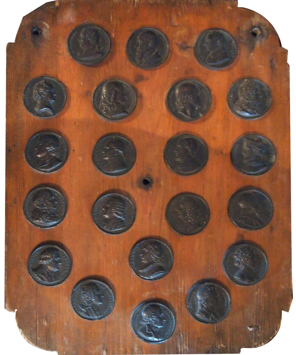 A Wooden Plate Containing Medals