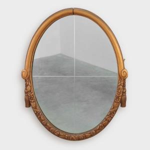 Miroir Art déco ovale français en chêne sculpté et doré, vers 1925