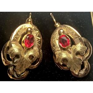12-karat Gold Bourbon-style Earrings With Finely Chiseled Leaves And Central Garnets.