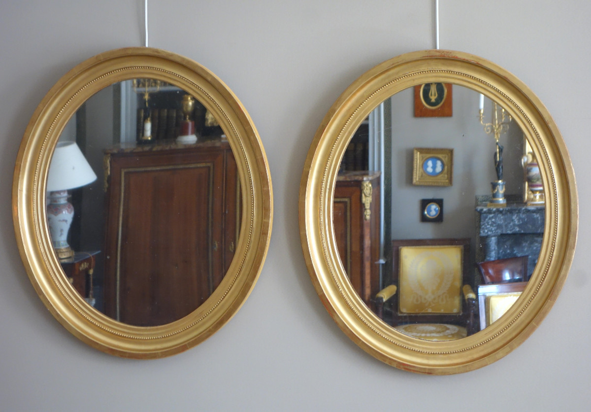 Pair Of Large Oval Mirrors In Gilded Wood And Mercury Glass In The Louis XVI Style