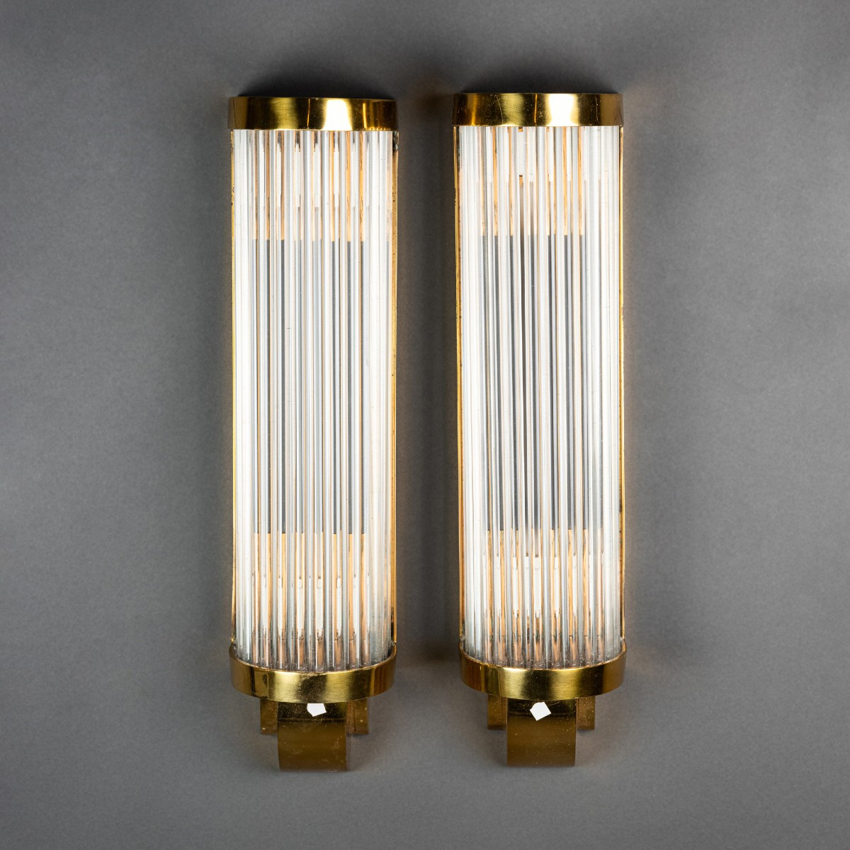 Pair Of Art Deco Style Wall Sconces With Gilded Metal Bases And Glass Tubes
