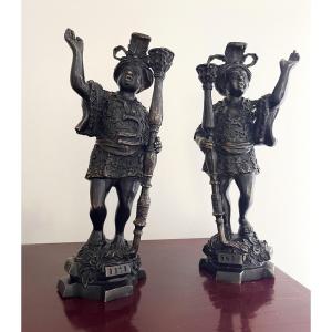 Pair Of Bronze Figures With A Brown Patina, Serving As Candlesticks