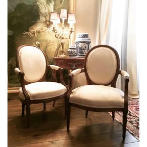 Two Cabriolet Armchairs Louis XVI Period. One Stamped Louis Delanois Received Master In 1761