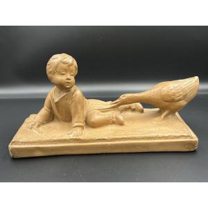 Sculpture ancienne en terre cuite émaillée – Enfant et oie – signée