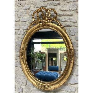 Antique Oval Mirror With Louis XVI Style Knot Pediment And Beading, 87/60.5cm, Gilded With Floral Gold Leaf