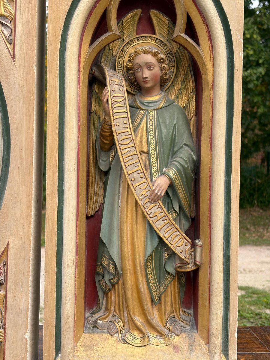 A Stone Altarpiece In The Neo-gothic Style, Adorned With Angels And The Lamb Of God-photo-1