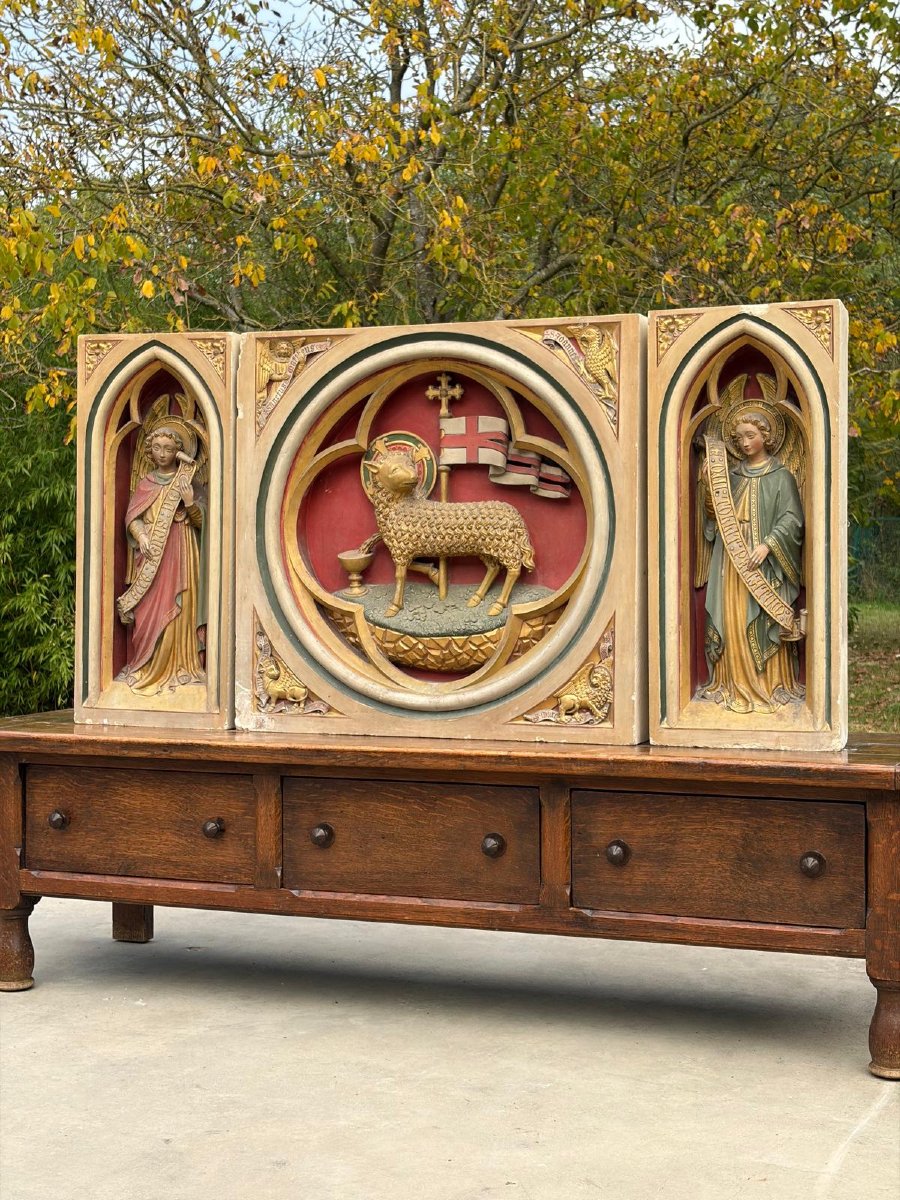 A Stone Altarpiece In The Neo-gothic Style, Adorned With Angels And The Lamb Of God
