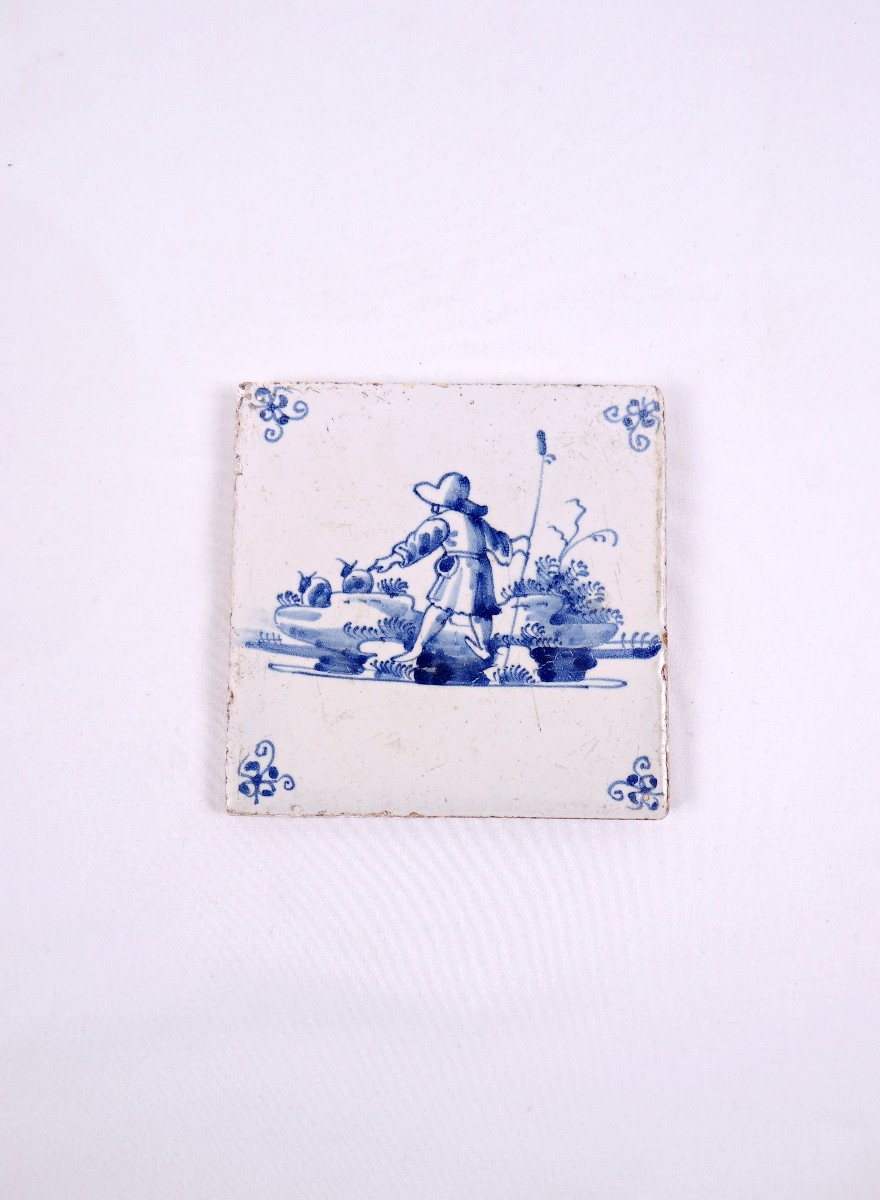 18th-century Delftware Tile Depicting A Peasant Scene With A Farmer Seen From Behind