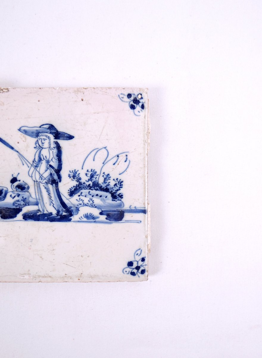18th-century Delftware Tile Depicting A Peasant Woman With A Stick, Facing Forward-photo-1