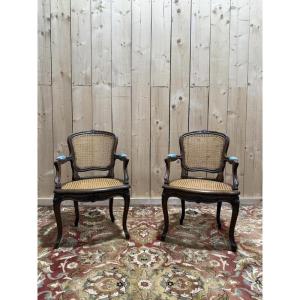 Paire de fauteuils de style Louis XV en cannage 