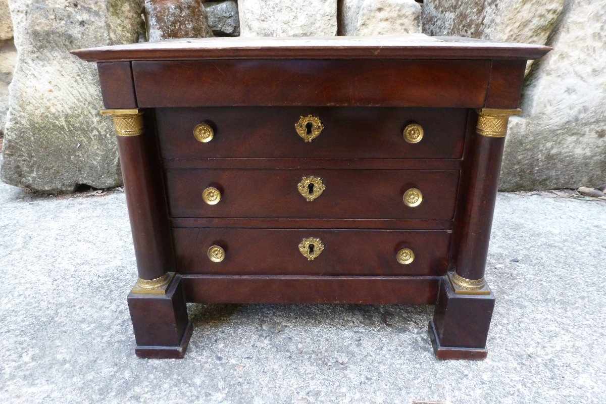 A Small Version Of An Empire-style Chest Of Drawers