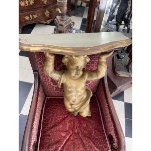 Console murale baroque en bois sculpté et doré à figure d’angelot