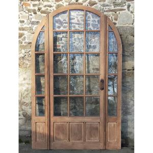 Porte vitrée ancienne cintrée avec son cadre en triptyque façon orangerie baie cloison 