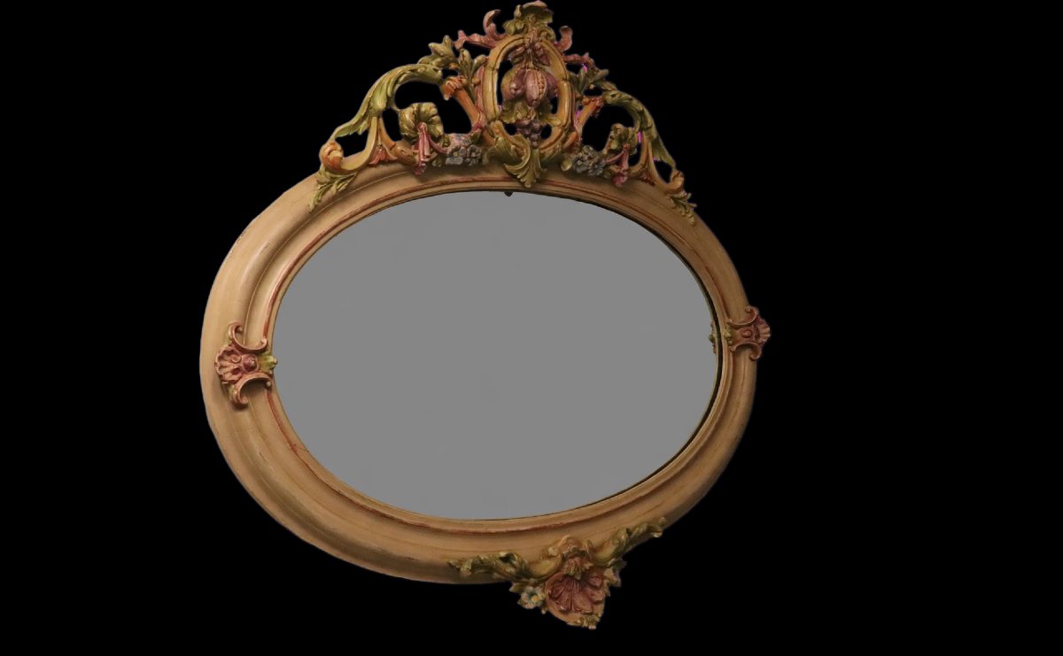 Miroir ovale en bois sculpté de style Italien à décor de fruits polychrome