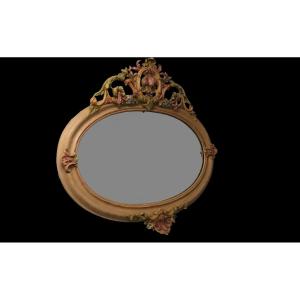 Miroir ovale en bois sculpté de style Italien à décor de fruits polychrome