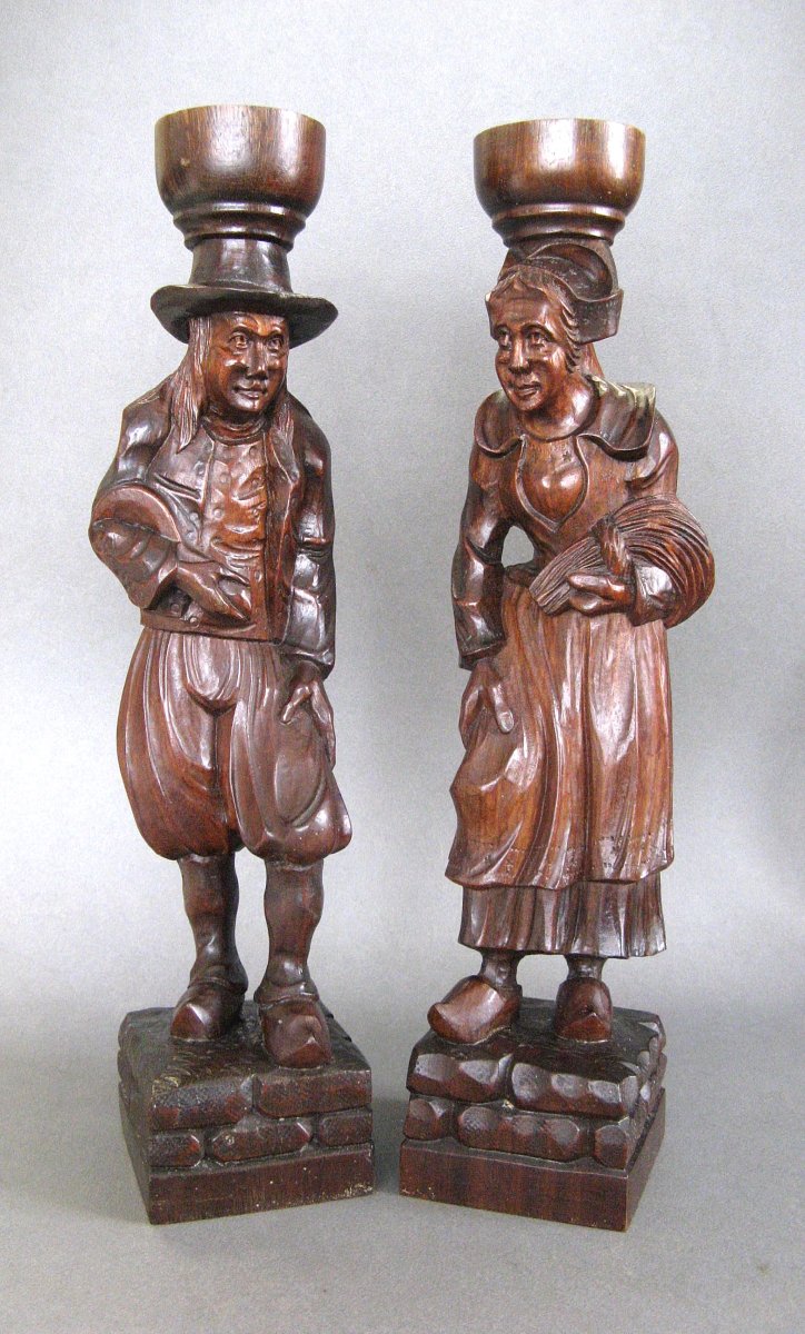 A Breton Couple In Carved Wooden Costumes.