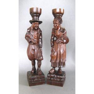 A Breton Couple In Carved Wooden Costumes.