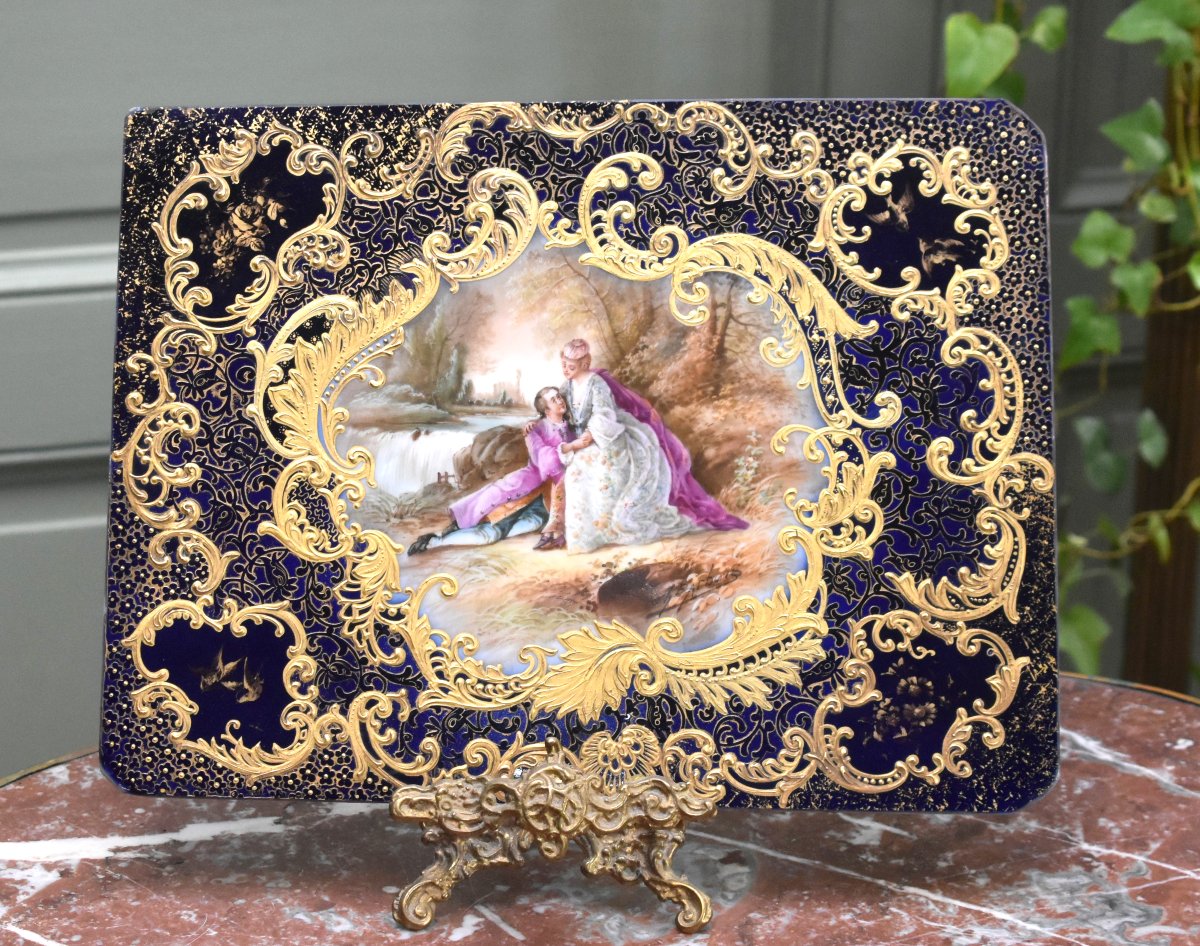 Ch. Barbois. Limoges Porcelain Plate Decorated With A Romantic Scene, Featuring Kiln Blue And Gold Leaf.