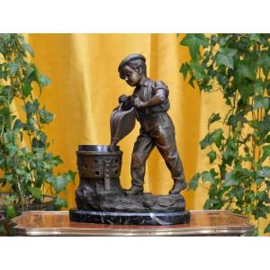 Statue Signed Grégoire, Spelter Sculpture Of A Young Boy With A Brazier And Bellows, Marble Base