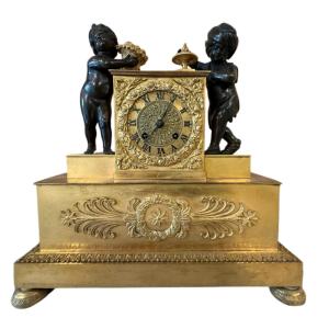 Gilded Bronze Clock With Children Playing In Brown Patina From The Restoration Period.
