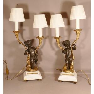 Clodion, Pair Of Putti Candlestick Lamps In Patinated And Gilded Bronze, 19th Century
