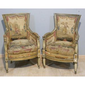 Paire de bergères d’époque Directoire en bois laqué et doré, tapisseries à scènes pastorales