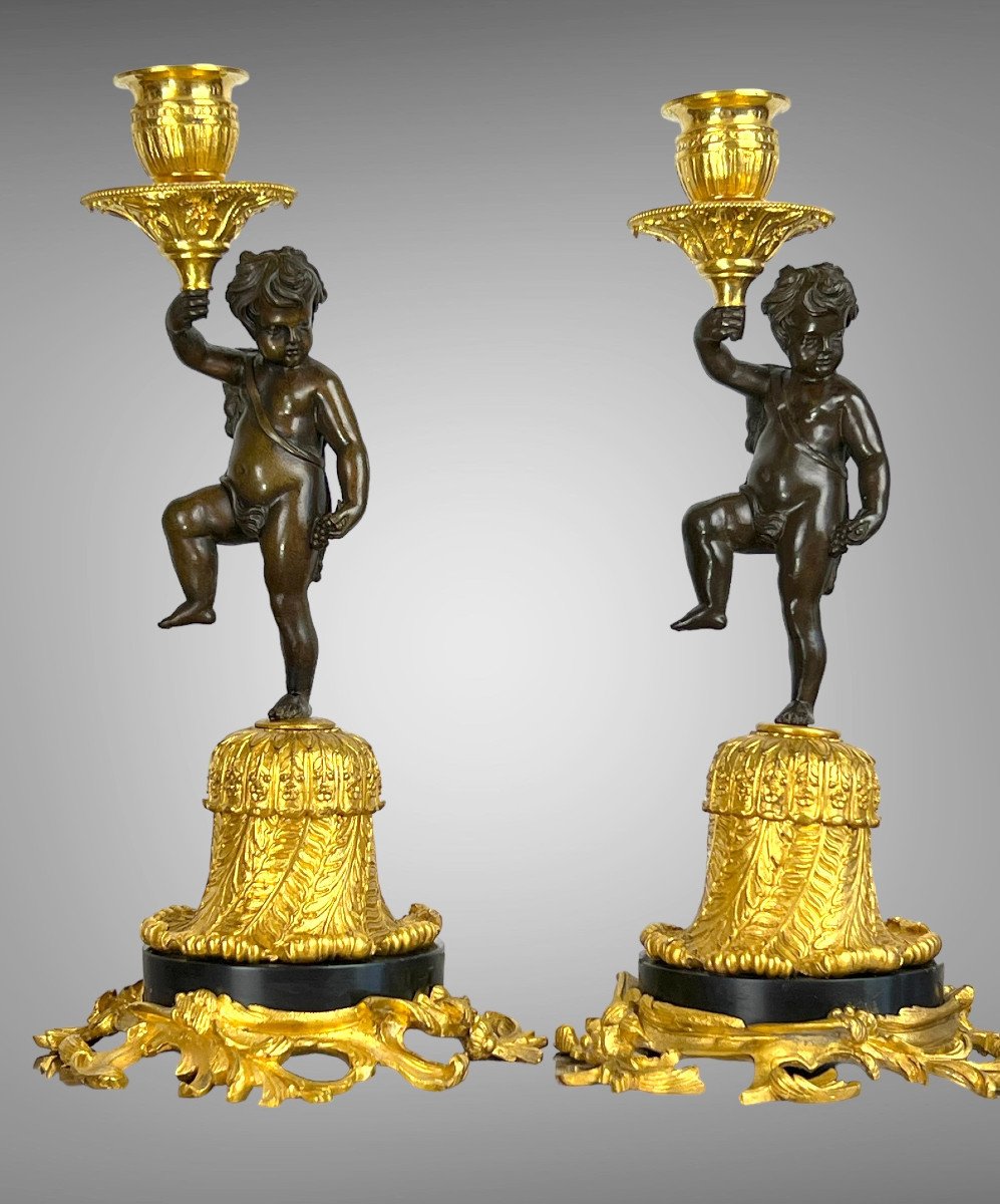 Pair Of Bronze Candelabras With Brown And Golden Patina With Cherb Decor From The 19th C.